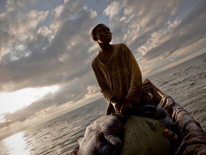 <p>Innocent al amanecer en la canoa en la que trabaja con su hermano Rigobert en el lago Kivu. Han recogido las redes y contado la captura, y se preparan para volver y vender el pescado en el mercado. Innocent dobla las pesadas redes y las envuelve en fundas de plástico para evitar cualquier deterioro, rotura o desgarrón que pudiera permitir escapar a los peces.</p>  <p>Si tienen suerte con la captura, las tripulaciones de las canoas pequeñas pueden esperar ganar unos 10 o 12 dólares al día, de los cuales solo les queda limpia una pequeña parte.</p>