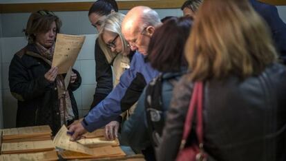 Votants seleccionen paperetes al col·legi Claret, de Chamartín (Madrid).