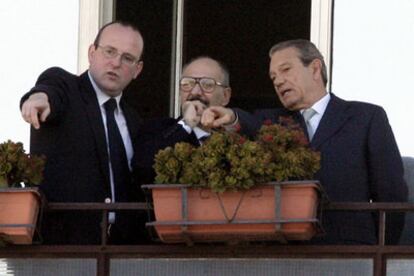 El portavoz del Papa, Joaquín Navarro Valls (dcha), con miembros de la seguridad vaticana hoy en la ventana de la habitación donde está ingresado el Pontífice.