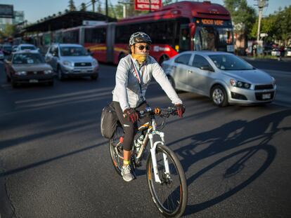 Un hombre monta una bicicleta mientras usa una máscara en la Ciudad de México, México, el 5 de abril de 2016.