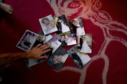 In this Wednesday, Jan. 11, 2017 photo, Sheikhmous Hussein, 33, a Syrian refugee from the northern district of Al-Ashrafiya, Aleppo, shows photographs from his wedding day, at his shelter in the refugee camp of Ritsona, Greece. "It was on the 8th of March 2014, these photographs were the only thing we managed to carry with us from Aleppo." Hussein said. (AP Photo/Muhammed Muheisen)