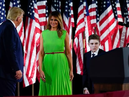 President Donald Trump appears on stage with first lady Melania Trump after he gave a speech from the South Lawn of the White House on the fourth day of the Republican National Convention, Thursday, Aug. 27, 2020, in Washington. Barron Trump is at right. (AP Photo/Alex Brandon)