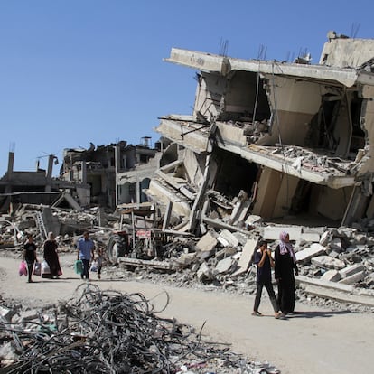 Palestinians walk among the rubble of damaged buildings, which were destroyed during Israel's military offensive, amid the ongoing conflict between Israel and Hamas, in Beit Lahia in the northern Gaza Strip, June 12, 2024. REUTERS/Mahmoud Issa