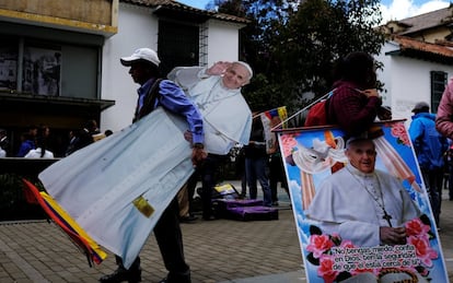 Un hombre transporta una imagen del papa en Bogotá.