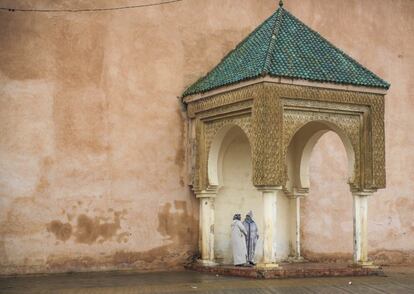 Women shelter from the rain next to the walls of the old Medina of Meknes, a UNESCO world heritage city, in Morocco, Thursday, Feb. 23, 2017. (AP Photo/Mosa'ab Elshamy)