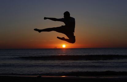 Salta de alegría, para competir, para ayudar; salta para escapar, para ver el mundo desde el aire, para descargar adrenalina, salta para alcanzar tus sueños...¡Salta conmigo! En la imagen, un hombre entrena en la playa de Trípoli, Libia, durante la puesta de sol. 6 de mayo de 2014.