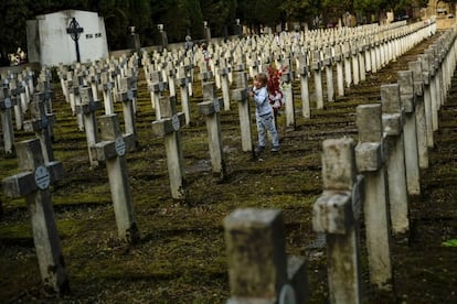 Un niño juega entre las tumbas del cementerio público de Pamplona (España).