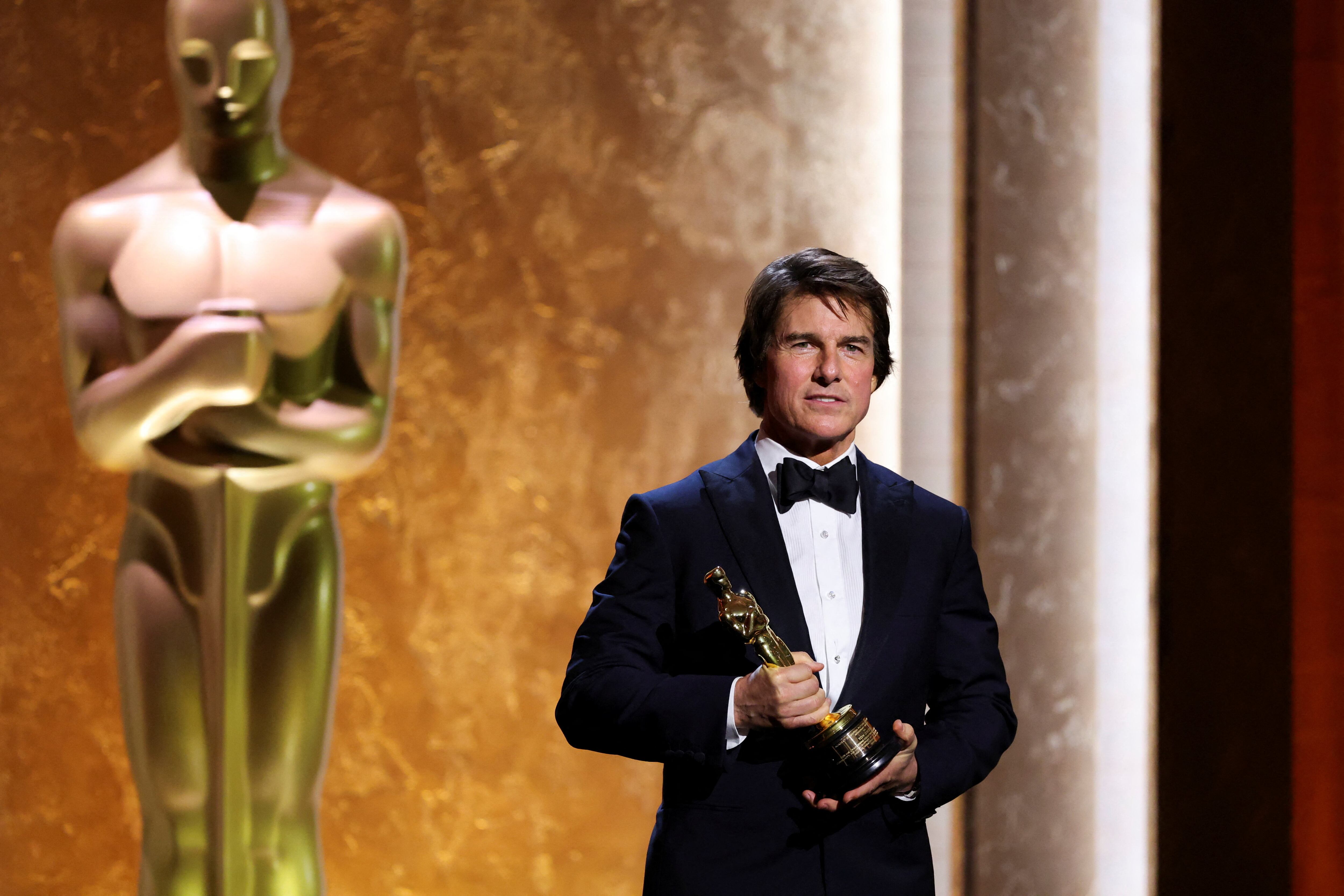 Dressed in a classic suit, Tom Cruise poses with his honorary Oscar during the Academy of Motion Picture Arts and Sciences' 16th Annual Governors Awards. His best accessory: the figurine.