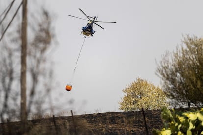 Un helicóptero trabaja este martes en la extinción del incendio forestal en Navalmoralejo (Toledo).
