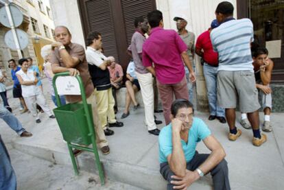 Varias personas aguardan para comprar pesos convertibles en una oficina de cambio de La Habana, en 2004.