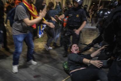Police officers clash with demonstrators outside El Prat airport in Barcelona.