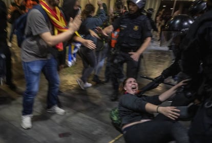 Police officers clash with demonstrators outside El Prat airport in Barcelona.