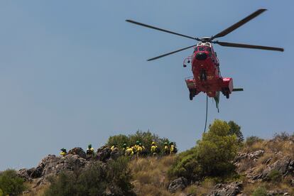 Miembros del Infoca toman tierra en una parte alta de la Sierra de Mijas (Málaga), este sábado. 
