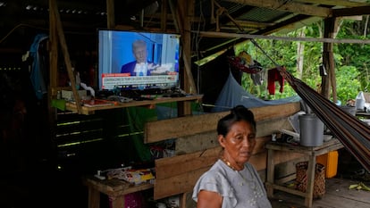 Una residente de Villa Caleta frente a una televisión que muestra a Donald Trump, presidente de Estados Unidos, en abril 2025.