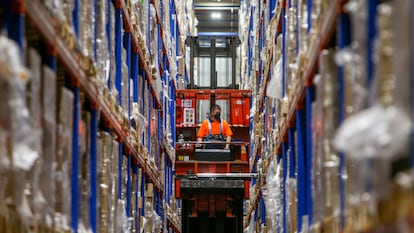 A worker places boxes filled with vaccines in a logistics center in Leganés in Madrid.