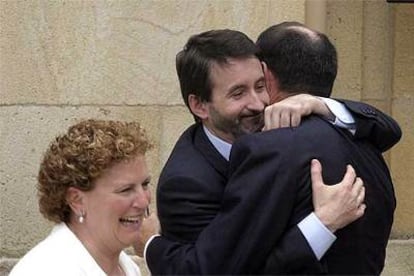 El líder del PNV, Josu Jon Imaz, en el centro, abraza al <i>lehendakari</i> Ibarretxe en presencia de la presidenta de EA, Begoña Errazti.