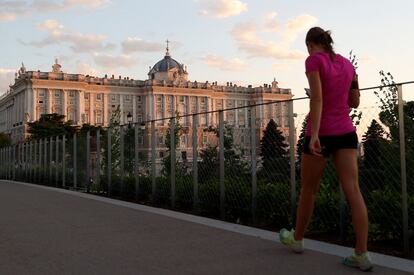 Una mujer camina, a última hora de la tarde del lunes, en los aledaños del Palacio Real de Madrid.