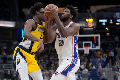 Philadelphia 76ers center Joel Embiid, right, moves against Indiana Pacers forward Serge Ibaka during the first half of an NBA basketball game in Indianapolis, Saturday, March 18, 2023.