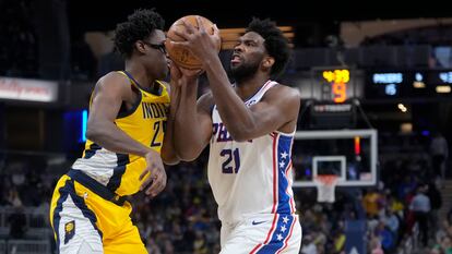 Philadelphia 76ers center Joel Embiid, right, moves against Indiana Pacers forward Serge Ibaka during the first half of an NBA basketball game in Indianapolis, Saturday, March 18, 2023.