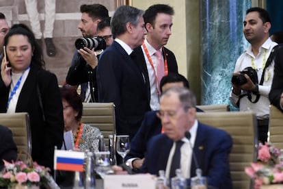 U.S. Secretary of State Antony Blinken, top center, walks past Russian Foreign Minister Sergey Lavrov during the G20 foreign ministers' meeting in New Delhi Thursday, March 2, 2023.