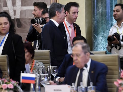 U.S. Secretary of State Antony Blinken, top center, walks past Russian Foreign Minister Sergey Lavrov during the G20 foreign ministers' meeting in New Delhi Thursday, March 2, 2023.