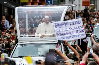 An activist holds up a sign during the pope’s visit to Dublin earlier this year.