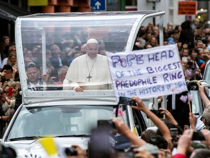 An activist holds up a sign during the pope’s visit to Dublin earlier this year.