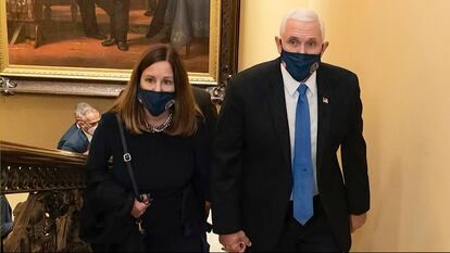 Mike Pence and his wife Karen walk at the Capitol.