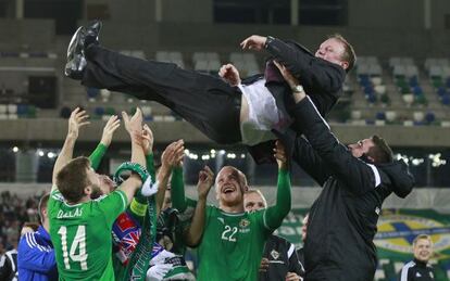 Los jugadores de Irlanda del Norte mantean al entrenador Michael O'Neill, tras la clasificación.