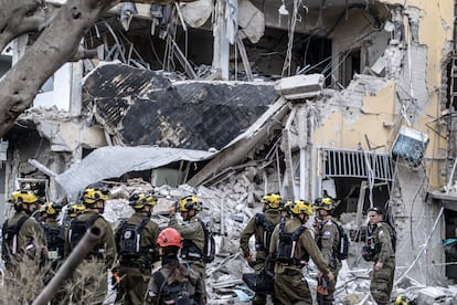Brigadas de defensa civil y bomberos israelíes continúan las operaciones de búsqueda y rescate después tras los ataques iraníes en Tel Aviv.