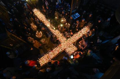 Los creyentes asisten a una ceremonia que conmemora el día de San Haralampi, protector de los apicultores, alrededor de una plataforma en forma de cruz cubierta con velas colocadas en tarros de miel, en la Iglesia de la Santísima Virgen en Blagoevgrad (Bulgaria), el 10 de febrero.