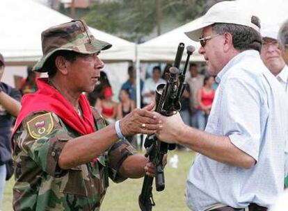 El jefe paramilitar Ramón Isaza entrega sus armas al comisionado de paz, en  2006.