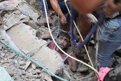 Palestinians rescue a survivor of Israeli bombardment of the Gaza Strip in Nusseirat refugee camp on Tuesday.