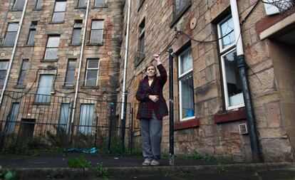 Una vecina de Glasgow frente al bloque de viviendas del que fue desahuciada con motivo de los Juegos de la Commonwealth de 2014.