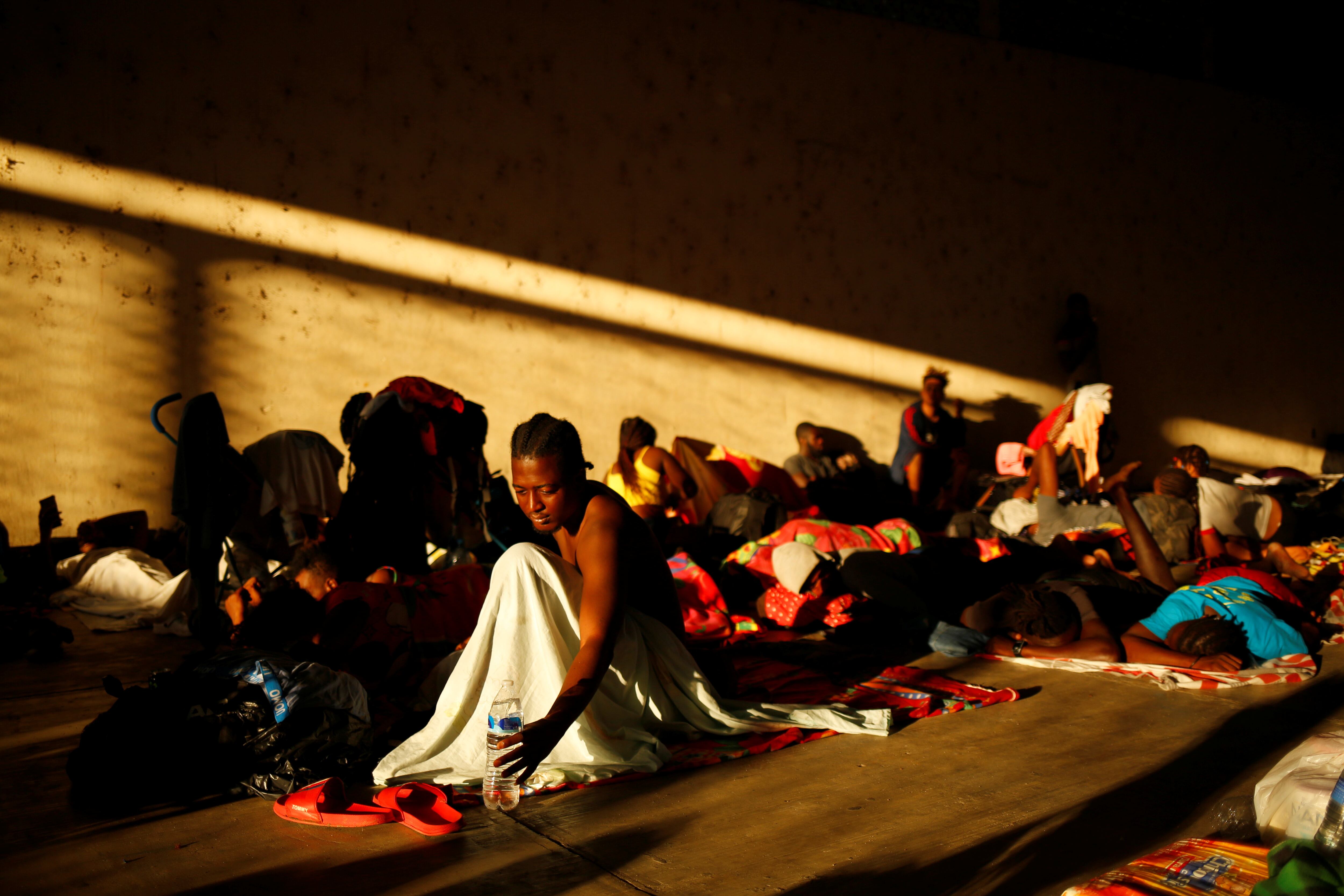 Migrantes de Haití descansan en una plaza en Escuintla, México.