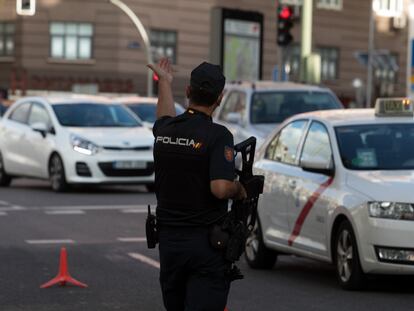 A police officer enforces the coronavirus restrictions on mobility in Madrid.