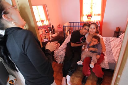 Ramón with his wife and son in the house where they live illegally in Puente de Vallecas, Madrid.