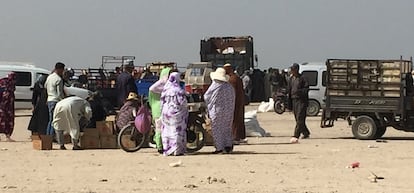 Moroccan soldiers handing out bottles of oil to residents of Dakhla in Western Sahara. 