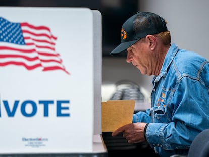 A voter fills out his ballot at the Fairfax County Government Center polling place in Fairfax, Virginia.