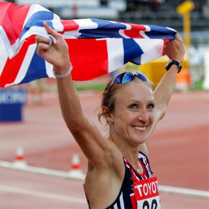 La atleta británica celebra su victoria y la medalla de oro en el maratón.