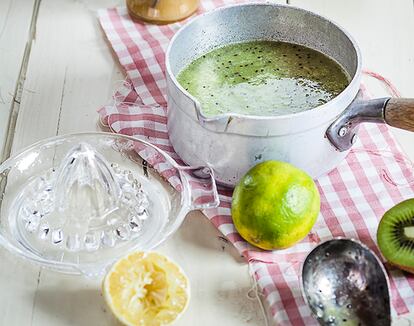 Chilled kiwi soup in pot with limes and honey