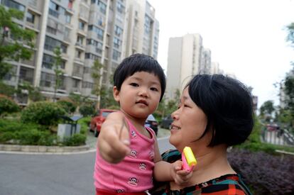 La niñera Peng Fengxiang regresa con Jiang en brazos al piso en el que vive con la familia. Cada vez es más habitual entre la población de clase media contar con una persona que ayude en las tareas del hogar y cuide de los hijos las 24 horas al día.
