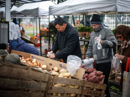 Grupo de pessoas compra numa feira de Buenos Aires.