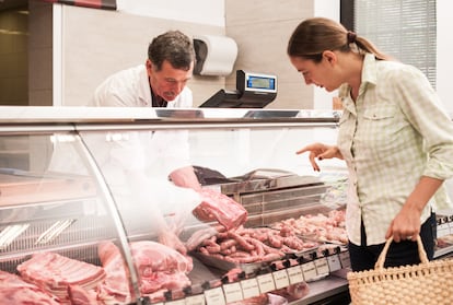 woman buying meat at the butcher shop