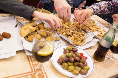 Una mesa con diversas raciones de 'pescaíto' frito.