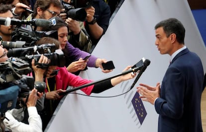 Pedro Sánchez talks to the media as he arrives at a European Union leaders summit.