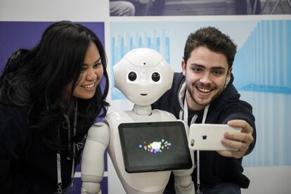 El robot Pepper, con dos estudiantes.