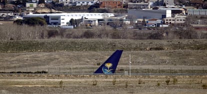 The tail of the Saudi Airlines flight on a runway at Terminal 4.