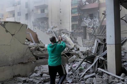 Un hombre hace una foto de los edificios destruidos, tras un ataque aéreo israelí en el barrio de Dahieh en Beirut, este miércoles. 