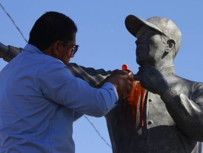 Un empleado limpia con salsa una estatua en Juárez.